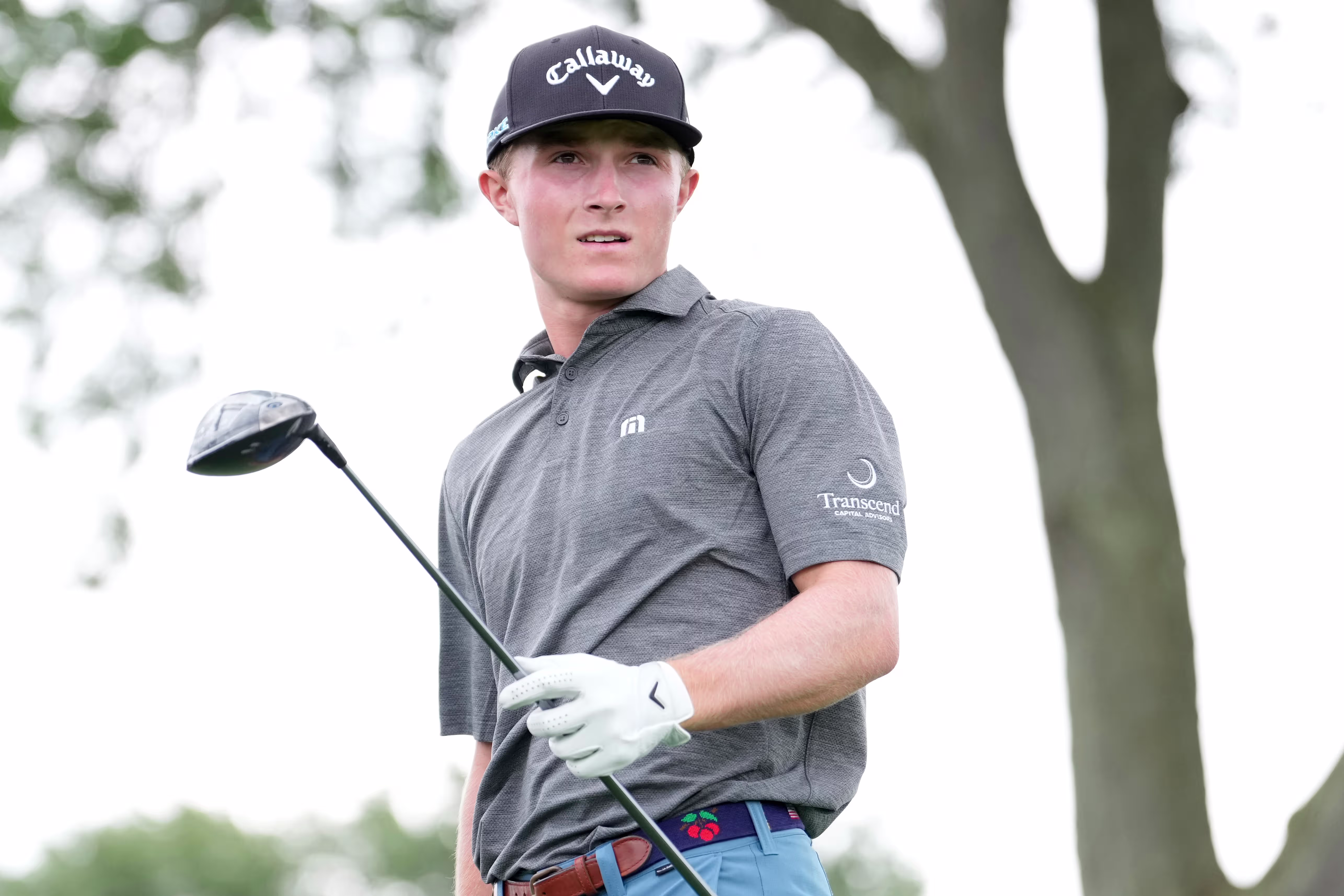 Blades Brown holds a driver on the golf course
