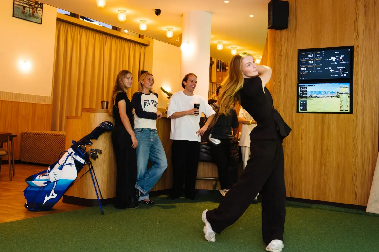 A group playing in a bay at Flight Golf