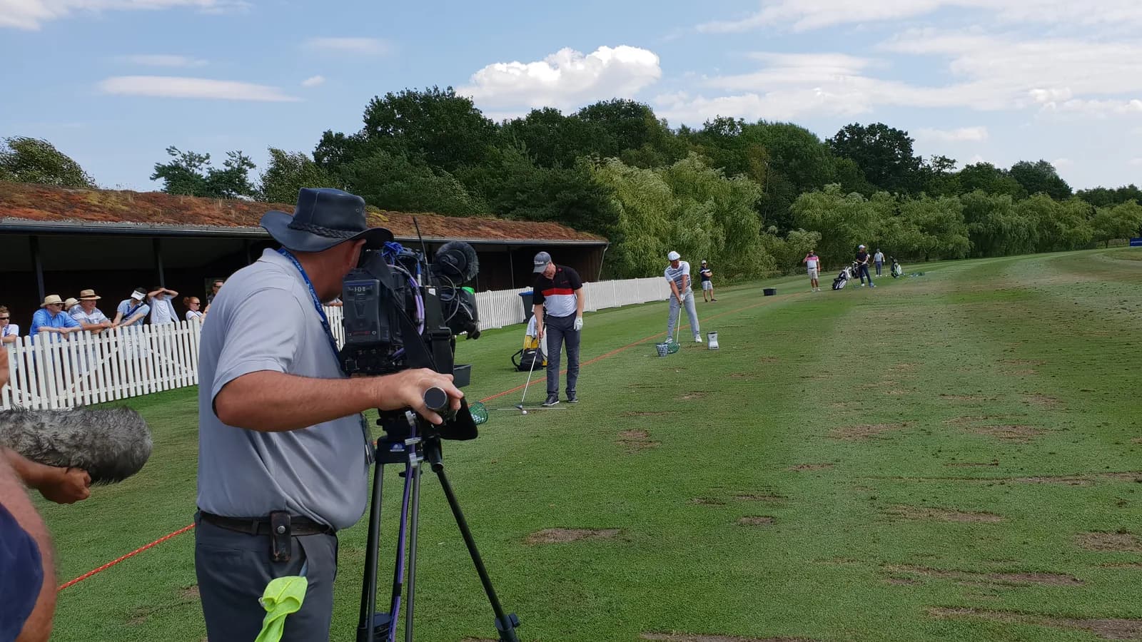 A television cameraman films players on the range at the 2018 European Open